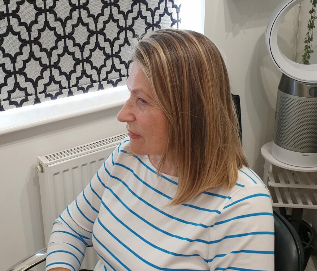Mid-length mousey hair before the cut and style into a chin-length short bob.